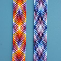 two knitted ties sitting next to each other on top of a blue tablecloth