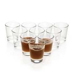 six shot glasses filled with different types of drinks