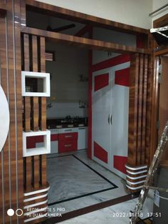 the interior of a kitchen with red and white accents on the walls, cabinets, and flooring