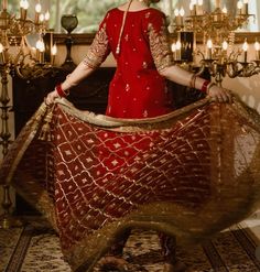 a woman in a red dress is posing for the camera