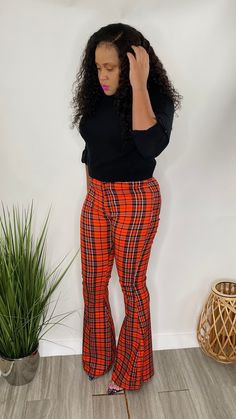 High Waist Bell Bottom Pants with pockets and button front in a red plaid print. Model is wearing a size Small High waist bell bottom red plaid Red Checkered, Checkered Print, Pants With Pockets, Bell Bottom Pants, Bell Bottom, Plaid Print, Striped Pants, Red Plaid, Bell Bottoms