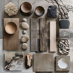 many different types of rocks and wood are arranged on the table top, including one with a vase