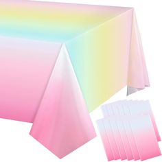 a table cloth with pastel colors is shown next to six sheets of paper that have been folded