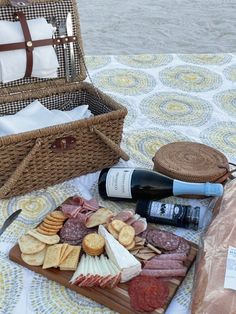 a picnic with wine, cheese and meats