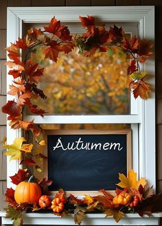 an autumn chalkboard with fall leaves and pumpkins on the mantle in front of a window