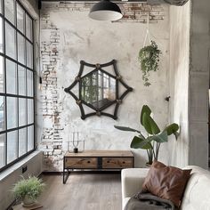 a living room filled with furniture and a large mirror hanging on the wall above it