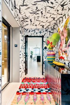 the hallway is decorated in bold colors and patterns