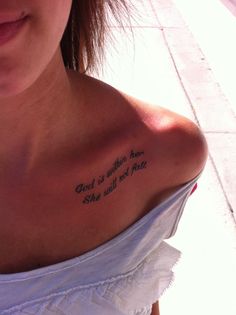 the back of a woman's shoulder with a tattoo saying god is the reason