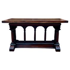 an old style wooden table with columns and carvings on the top, against a white background