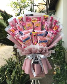 a bouquet of candy wrapped in pink ribbon