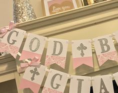 a pink and gray banner that says god's baby girl hanging from a mantle