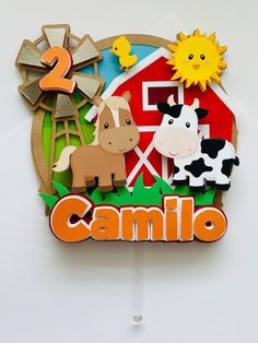 a wooden sign with farm animals and the word camilo on it's side