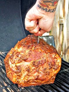 a person is cutting into a piece of meat on a grill