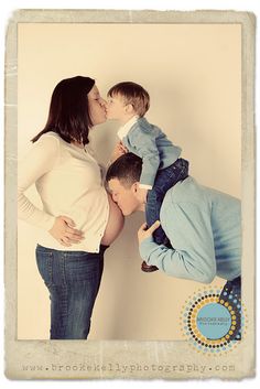 a woman kissing a man's cheek while he kisses his son on the nose