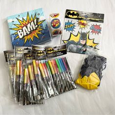 the contents of a batman birthday party including markers, pencils, and napkins