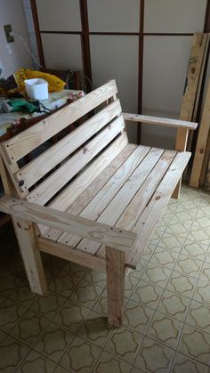 a wooden bench sitting on top of a tiled floor