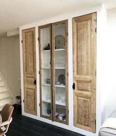 an empty living room with two wooden doors