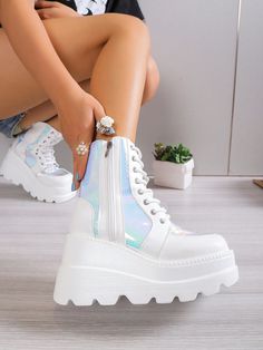 Elevate your style with our Holographic Lace-Up Grunge Punk Wedge Boots. Adorned with a holographic design, these boots are perfect for adding a touch of funky flair to any outfit. The lace-up feature provides a secure fit, while the wedge heel offers both height and comfort. Step into fashion-forward style with these boots. Color : White Closure Type : Side zipper Insole Material : Polyester Lining Material : Polyester Outsole Material : Polyurethane Upper Material : PU Leather Trendy High-top Wedge Boots With Chunky Platform, Trendy High-top Chunky Platform Wedge Boots, White High-top Wedge Boots For Spring, Trendy White High-top Wedge Boots, High-top Synthetic Platform Boots For Streetwear, Trendy Synthetic Wedge Boots With Chunky Platform, Trendy White Wedge Boots For Spring, Synthetic Round Toe Wedge Boots For Streetwear, Synthetic Wedge Heel Platform Boots For Streetwear