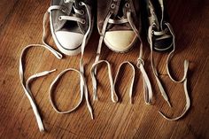 three pairs of shoes tied up to each other with the word sorry written on them