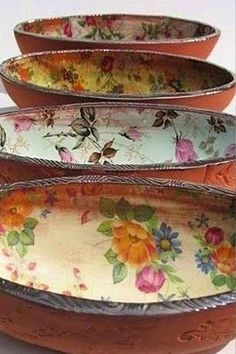 three bowls with floral designs are stacked on top of each other