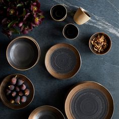 bowls and plates are arranged on a table