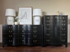 three black dressers with white lamps and pictures on them