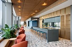 an empty restaurant with lots of seating and bar stools in front of large windows