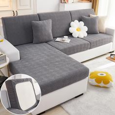 a living room with a gray couch and white rug