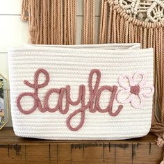 a white purse with the word sayfab on it sitting on a wooden table