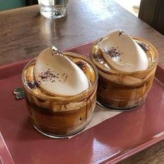 two desserts are sitting on a red tray