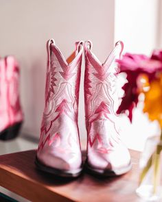 Maggie, our five-star darling, is the epitome of traditional western meets fashion. Elevated in playful metallic light pink, Maggie isn't just a cowboy boot; she's your go-to for every occasion. Her extra deep topline offers a super flattering silhouette that's endlessly versatile. Dress her up or dress her down—either way, Maggie promises to keep you looking fabulous from dawn till dusk. This boot is part of MC Personalization and can customize the Ear Pulls and/or add an interior Message Box. Light Pink Cowboy Boots, Pink Metallic Cowgirl Boots, Pink Western Boots For Ranch, Ponk Cowgirl Boots, Miron Crosby, Pink Fitted Western Mid-calf Boots, Women's Cowboy Boots, Scalloped Collar, Pink Luxury