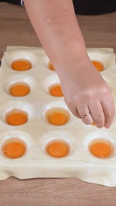 a person placing eggs in an egg tray