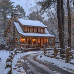 a house is lit up in the winter with snow on the ground and trees around it