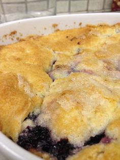 a blueberry cobbler is shown in a white dish