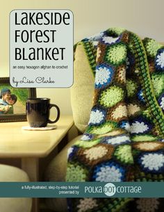 the cover of lakeside forest blanket is shown next to a table with a coffee cup on it