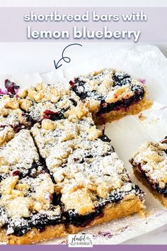 blueberry shortbread bars with lemon blueberry crumbs are on a white platter