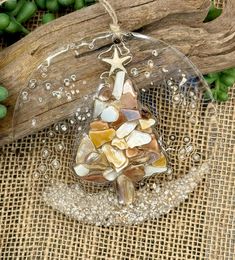 a glass ornament with shells and starfish on it