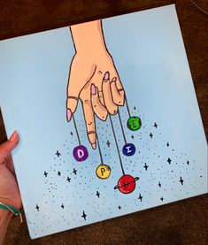 a drawing of a person's hand reaching for the stars and planets above them