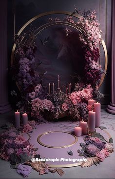 purple flowers and candles are arranged in front of a circular mirror with gold trimming