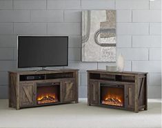 an entertainment center with two fireplaces and a flat screen tv