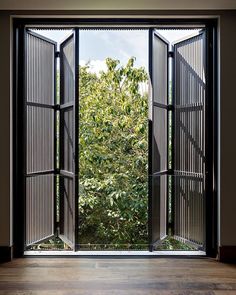 an open window with the view of trees outside