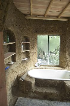 a bathroom with a tub and shelves in it