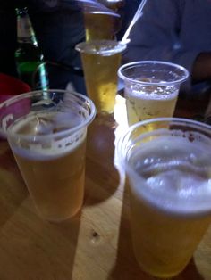 several glasses of beer are sitting on a table