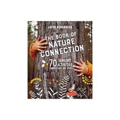 the book of nature connection is on display in front of a tree with hands reaching for it