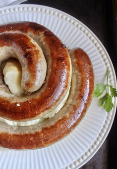 two hot dogs on a plate with butter and parsley