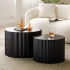 two black tables sitting in front of a white couch