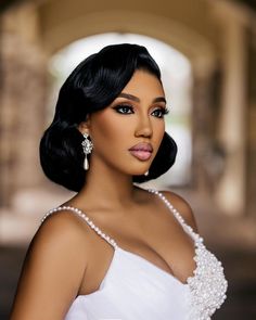 a woman in a white dress with pearls on her head and hair styled to look like an old hollywood star