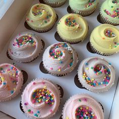 cupcakes with frosting and sprinkles in a box