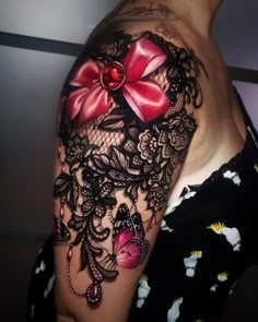 woman's half sleeved tattoo with red bow and lace