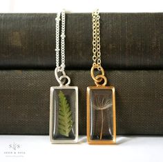 Our Large Rectangle pendant is available in 24k gold plated or .999 sterling silver plated and is available in your choice of real preserved botanical: Fern is a symbol of sincerity Dandelion Seed is symbolic of wishes Chain is 20" long, gold or silver plated brass, choose from a plain chain or a satellite chain. Ships in a gift box. The symbolism of the botanical is printed on a tag that is attached to your jewelry. Materials are tarnish resistant. Please see our care section for info on keeping your piece lovely for years to come. All materials are nickel and lead free. Handmade Gold Necklace, Rectangle Necklace, Rectangle Pendant, Dandelion Seed, Botanical Jewelry, Gold Necklaces, Glass Ideas, Timeless Jewelry, Handmade Gold